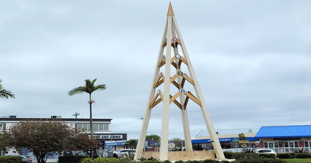 Professional home inspector at a waterfront property in Cape Coral, Florida, checking the seawall and dock